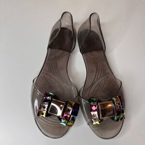 jelly flat sandals in a translucent smoke-gray color featuring large decorative